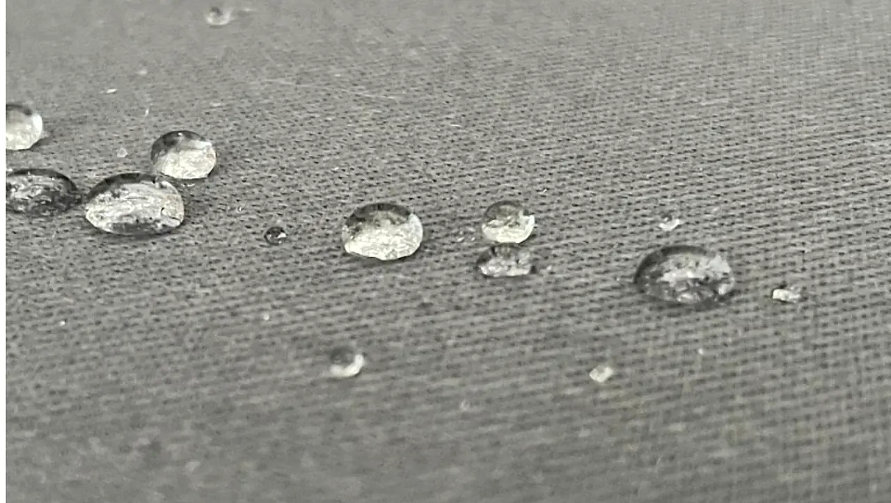 Water sitting up in beads on fabric treated with SoftGuard